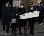 Et forældrepar bærer kisten med deres barn, som blev stukket ihjel i en vuggestue i Belgien. Barnet blev begravet i slutningen af januar. 