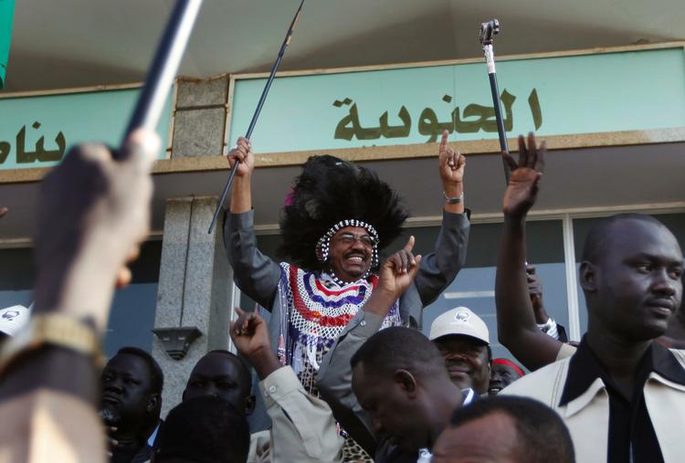 Sudanese President Omar al-Bashir dances in front of supporters holding a spear and wearing a southern Sudan traditional costume during a rally protesting against the International Criminal Court arrest warrant isssued against him. 
