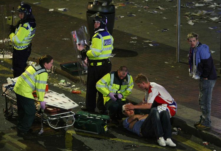 Efter finalen 14. maj 2008 kom det til blodige sammenstød mellem fodboldtilhængere i Manchesters gader. Her bliver en Glasgow Rangers-tilhænger behandlet. Fem Rangers-tilhængere er i dag blevet anholdt, mistænkt for at stå bag urolighederne. Arkivfoto. 