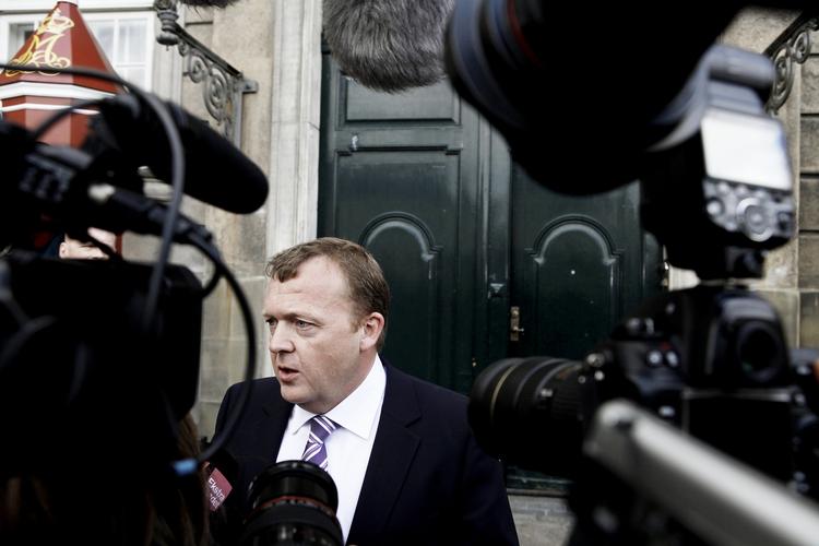 Lars Løkke Rasmussen emerging from the royal palace as Denmark's new prime minister. 
