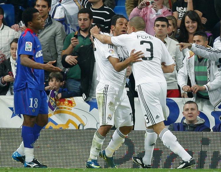 Pepe (th) holdes tilbage af holdkammeraten Marcelo Vieira Da Silva, så portugiseren ikke forløber sig yderligere i Real Madrids kamp mod Getafe. Arkivfoto. 