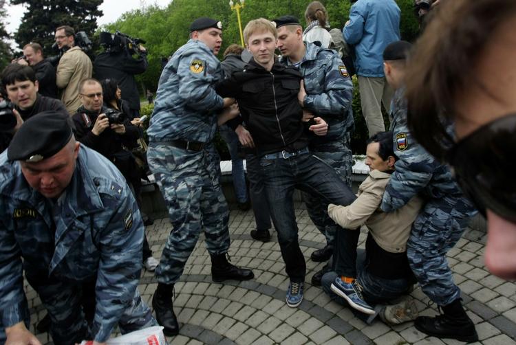 Russiske betjente arresterer demonstranter og fører dem væk i busser. 