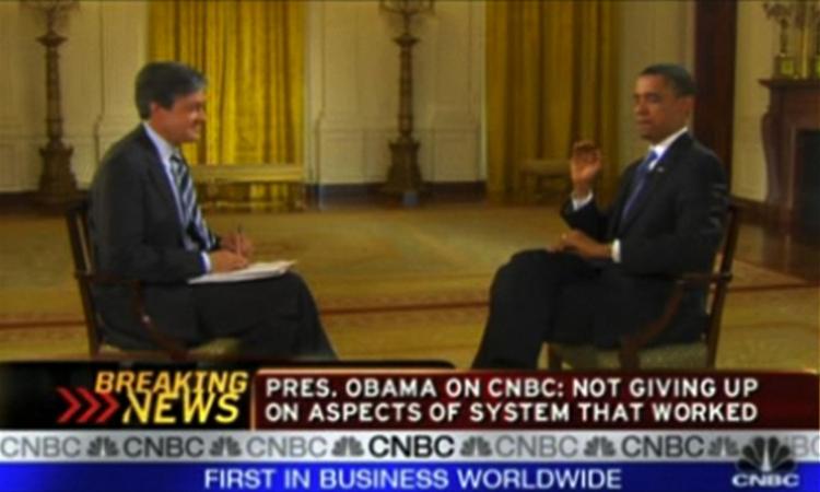 Præsident Barack Obama i sekundet inden, han klasker til fluen under interviewet med CNBC-journalisten John Harwood. 