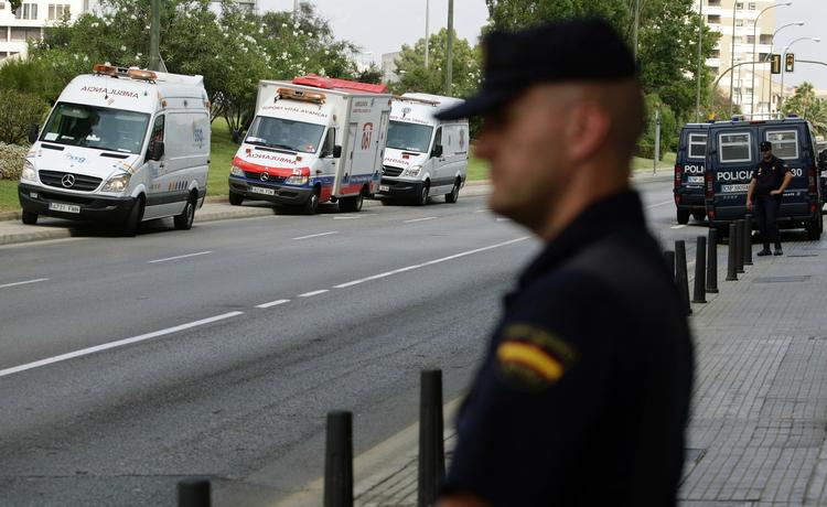 En spansk politimand patruljerer området omkring bombesprængningen. 