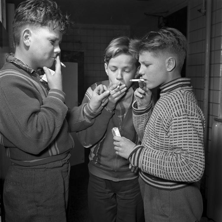 Rygningens status har ændret sig en del siden disse drenge tog sig en smøgpause i frikvarteret. Hvordan er det på dit barns skole eller institution. Er rygningen helt forvist eller er der stadig rygerum? 