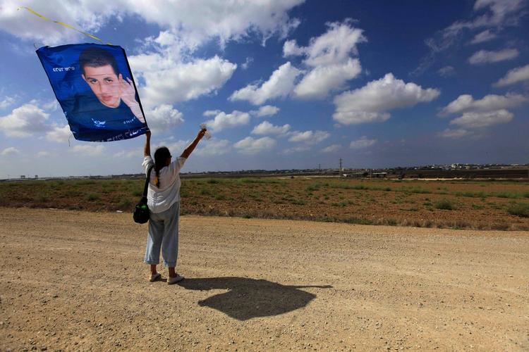 krigsfange. En israelsk kvinde flagrer med den tilfangetagne israelske soldat Gilad Shalits billede ud for den israelske grænse til det palæstinensiske område Gaza. 