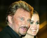 Levende. Den franske rockstjerne Johnny Hallyday kan fejre jul med sin hustru Laeticia (th) og hans to døtre, efter han er sendt hjem fra hospitalet. 