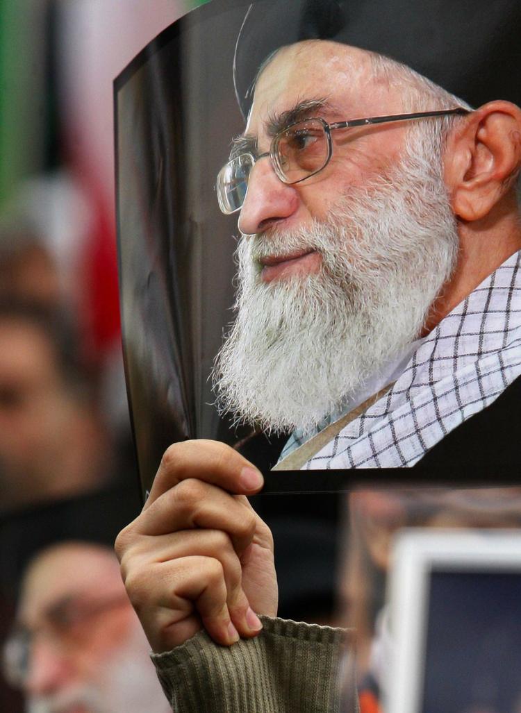 OPBAKNING. Tusinder af regeringssympatisører udkommanderet til en demonstration i dag i Teheran, hvor formålet var at fordømme oppositionen. Her holder en kvinde et billede af landets øverste religiøse leder, ayatollah Ali Khamenie. 
