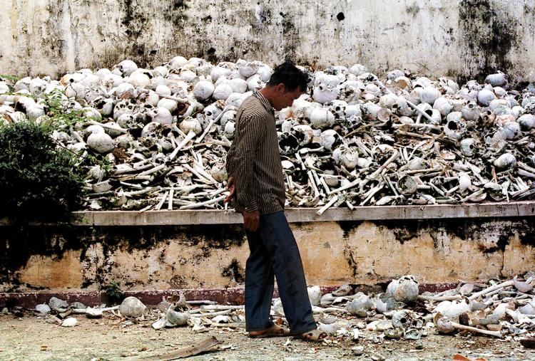 Udrydning.  En cambodjaner går forbi en af Pol Pots mange 'killing fields', her i udkanten af Phnom Penh. Foto: Richard Vogel/AP 