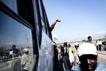 Beboere forsøger at komme ud af Port-au-Prince ved at fylde en bus mod Port Liberte til bristepunktet. 