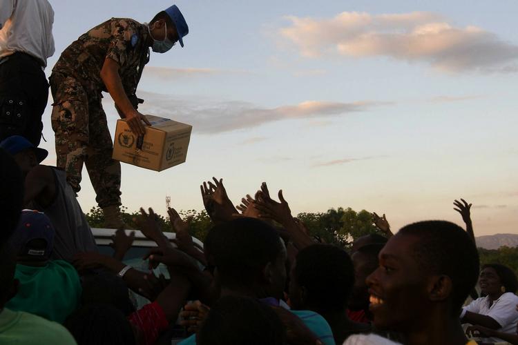 HJÆLP. Der er hårdt brug for hjælp fra resten af verden, hvis situationen på Haiti skal stabiliseres. Her er den en jordansk FN-medarbejder, der deler mad ud til de overlevende. 
