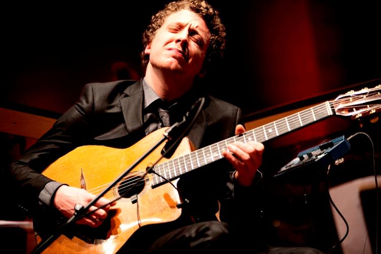 Den kun 24-årige franske guitarvirtuos Adrien Moignard står ikke tilbage for stilikonet Django. Fredag aften var han det musikalske centrum for hyldestkoncerten til sigøjnerjazzens fader Django Reinhardt, der ville være fyldt 100 år i dag. Foto: Miriam Dalsgaard 