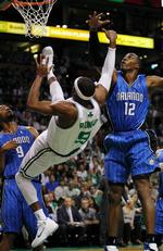 ryglanding. Boston Celtics Rajon Rondo (9) falder efter et skudforsøg i semifinalen mod Orlando Magic. 