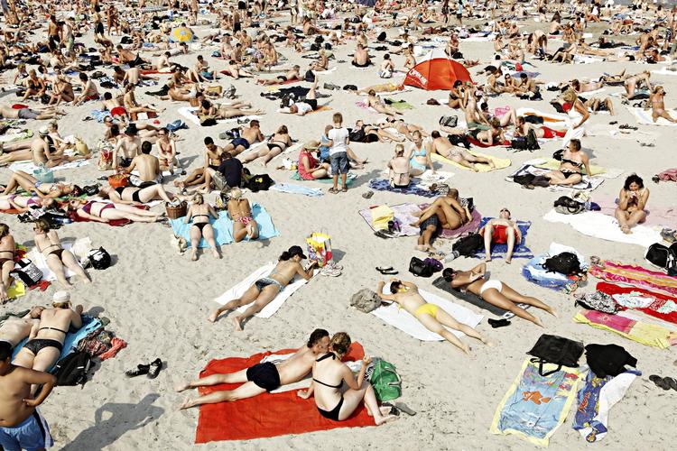 strandliv. Folk vælter ud til stranden som her ved Svanemøllen, og det giver livredderne travlhed. Der har dog kun været få direkte livsfarlige situationer. 