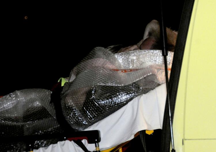 A rescued man is brought into an ambulance near Mandal, Norway  late Wednesday in Norway. Four people are missing and two were rescued when a boat capsized in the sea south east of Mandal 