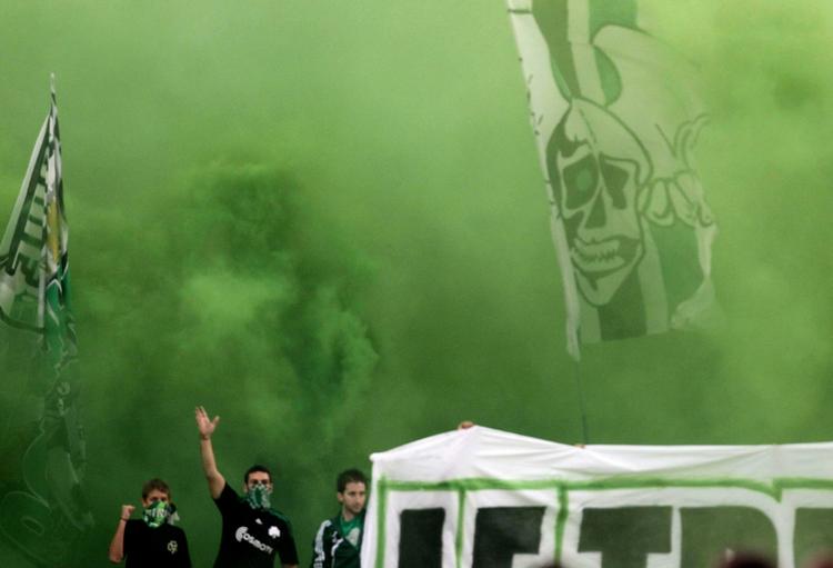 Panathinaikos fans react during a Greek Championship soccer match between Panathinaikos and Panionios at the Olympic Stadium in Athens last Saturday. 