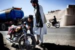 An Afghan policeman checks a motorbike for weapons and explosives. Archive. 