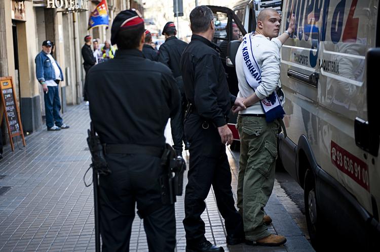 respektløs. Det spanske politi er m ødt talstærkt op i Barcelonas gader for at skride ind mod optræk til uro. Her bliver den danske FCK-fan sat fast i en af politiets salatfade. 