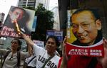 Pro-democracy protesters hold the picture of imprisoned Chinese dissident and Nobel Peace Laureate Liu Xiaobo with the words "Release Liu Xiaobo" as they march to China's Liaison Office in Hong Kong on Oct. 10. 