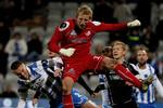 Odense. Randers' målmand, David Ousted, bokser bolden væk for næsen af hjemmeholdet OBs Espen Ruud i superligakampen i Odense mandag aften. 