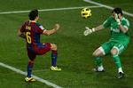Barcelonas Xavi Hernandez løfter bolden over Real Madrids målmand Iker Casillas. 