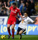vrid. Jamie Carragher fik beskadiget sin skulder alvorligt i en nærkmap i slutningen af Liverpools kamp mod Tottenham. 