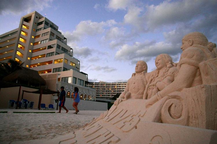 klimakommentar. Aktivister har bygget en sandskulptur ved FN's klimakonference i Cancun. 