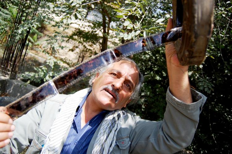 Kassem Karimi fra Afghans Film står ude i haven ved det afghanske filmarkiv, hvor afbrændte rester af de falske filmruller stadig ligger spredt blandt skrald, jord og planter. Arkivfoto. 