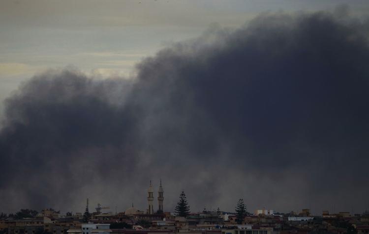 Smoke billows over the outskirts of Benghazi this morning. Explosions shook Benghazi early on Saturday while a fighter jet was heard flying overhead. 