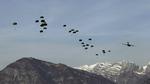 U.S. troops parachute out of a C-17 plane flying over Maniago, near the NATO airbase of Aviano, Italy, during an exercise yesterday. 
