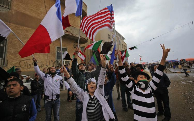 Hyldest. Unge libyere vifter med flag fra koalitionens lande efter fredagsbønnen i Benghazi. 