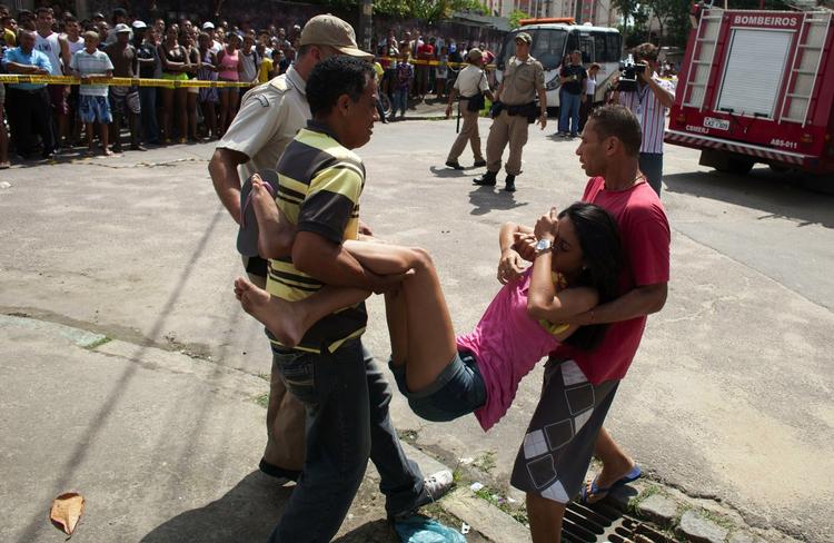 Forfærdelse. Forældre så børn og unge blive båret ud af skolen i Rio de Janeiro, hvor en mand gik ind og skød 12 børn og sårede flere andre. 