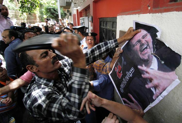 Vrede. En syrisk demonstrant viser sin vrede ved at banke skoen mod et billede af den syriske præsident Bashar Assad. Episoden fandt sted foran den syriske ambassade i Kairo. 