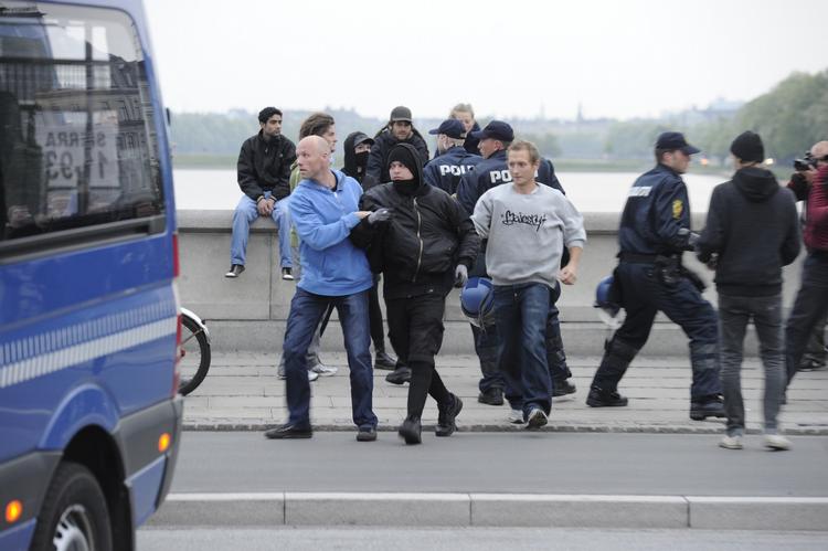 Anholdt. Politiet fører en af de 65 anholdte væk på Dronning Louises Bro på Nørrebro. 