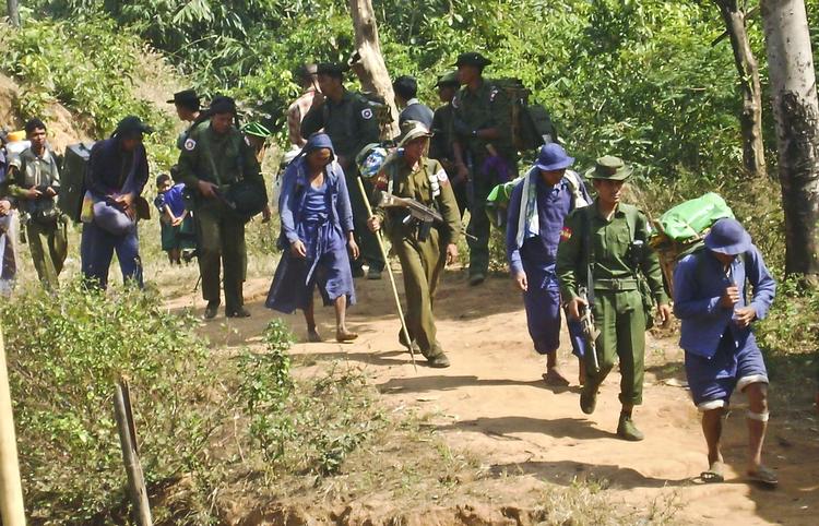 MENNESKERET. I dette billede fra januar i år går blåklædte civile, der bliver tvunget til at arbejde for hæren, sammen med soldater. 