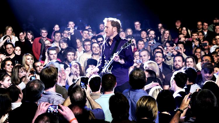 Europæisk. »Mange mennesker, der ser mit show i USA, siger faktisk, at mit show og min humor næsten er mere europæisk, end den er amerikansk«, siger Conan O'Brien, der blandt meget andet også spillede guitar på sin stand-up-turne. Foto fra filmen: Miracle Film