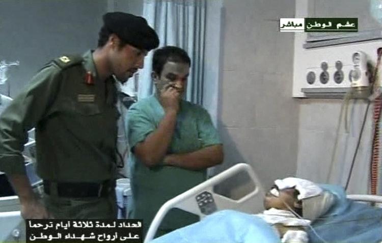 militærmand. Dette billede fra 10. august viser Khamis Gaddafi (tv.) på et hospital i Tripoli, hvor han besøger en såret soldat. 