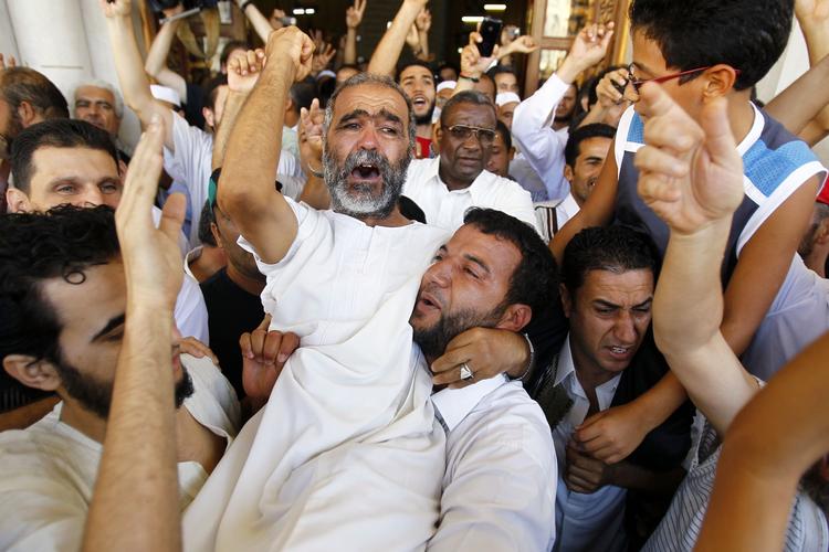 glædesrus. Libyske mænd jubler efter fredagsbønnen i går udenfor Jamal Abd Nasser-moskeen nær Den Grønne Plads i Tripoli. 