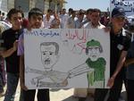 oprør. Dette billede stammer ifølge aktivister fra en demonstration i landsbyen Harma, hvor drenge fremviser en tegning af Syriens præsidents Bashar Assad (tv.) og Libyens Moamar Gaddafi med ordene: 'Træd tilbage'. 
