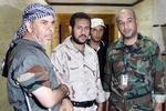Anklager. Den libyske oprørsleder Abdel Hakim Belhadj anklager briterne for at være involveret i hans tilfangetagelse under Gaddafi-styret. Her ses Belhadj i midten omgivet af to andre oprørsledere. 