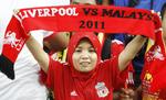 Verdensomspændende. Liverpool FC har masser af fans over hele jordkloden. Her en kvinde fra Malaysia, der så Liverpool spille en træningskamp i juli 2011. 