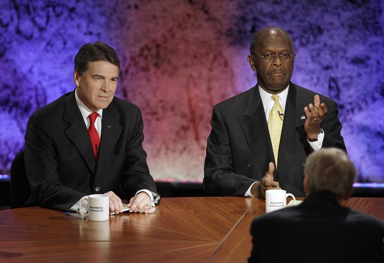 KAMPHANER. Herman Cain (th) og Rick Perry (tv) kæmper om at blive republikanernes udfordrer til Barack Obama. 