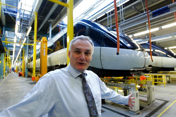 Archive picture of DSB Director Frank Olesen in maintenance and repair sheds, with IC4 in the background. 