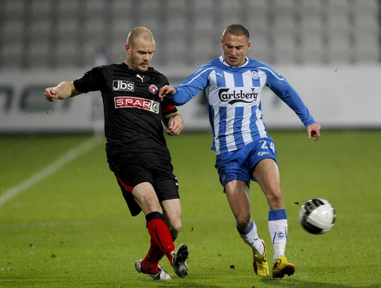 FC Midtjyllands Kristian Bak Nielsen forsøger at snuppe bolden fra Bashkim Kadrii fra OB. 