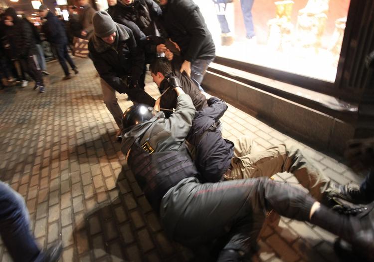 PROTEST. En fotograf fra nyhedsbureauet AP siger, at han blev holdt tilbage af politiet og blev bedt om at slette de billeder, han havde taget. På dette billede falder en politimand ned, da han forsøger at tilbageholde en demonstrant. 