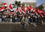 Pro-assad. Tilhængere af Bashar al-Assad demonstrerer i dag i Damaskus, efter 26 mennesker blev dræbt af en selvmordsbomber fredag. 