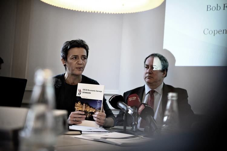 Economy Minister Margrethe Vestager receives the OECD's Economic Survey on Denmark from the OECD's Robert Ford. 