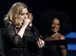 Pause. En tydelig rørt Adele modtog 12. februar seks priser ved årets Grammy Awards -blandt andet prisen for 'årets album' . I baggrunden ses Diana Ross. 