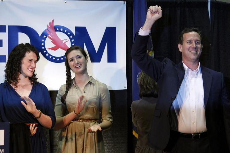 Ukuelige. Rick Santorum og hans familie smilede stort under nattens tale efter nederlaget i Illinois. Foto: Matt Rourke/AP 
