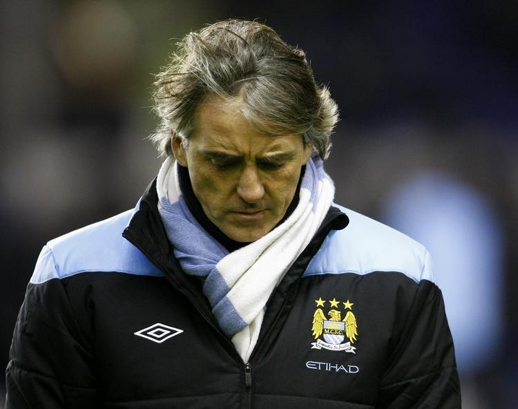 taktik? Manchester City-manager Roberto Mancini virker udadtil opgivende, når han taler om kampen om mesterskabet. 